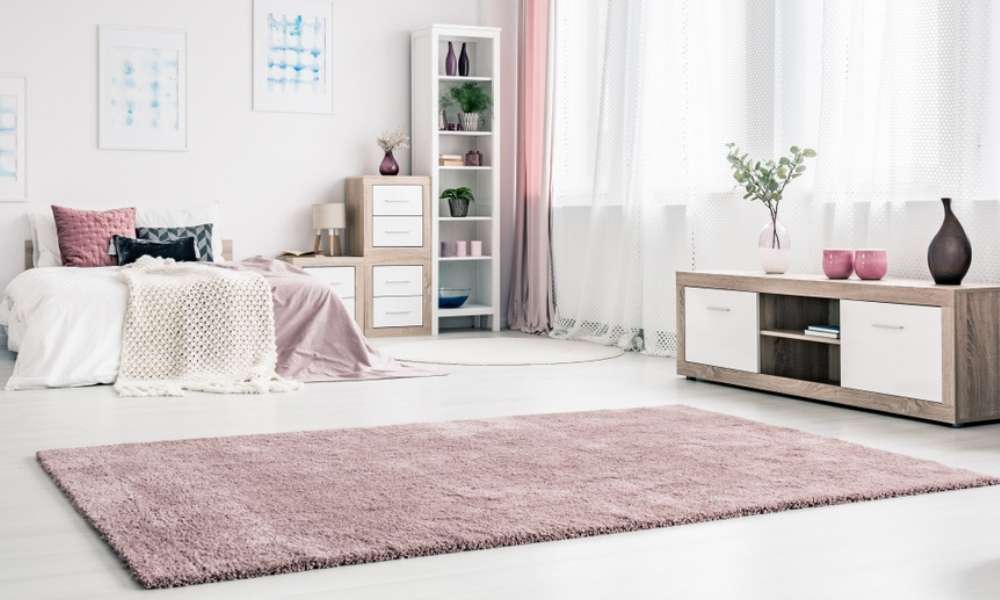 How to position the area rug in a bedroom